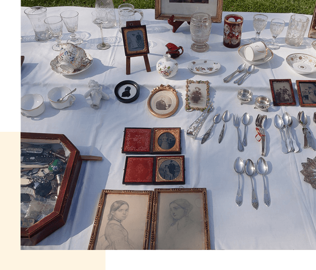 An estate sale website displaying a multitude of items for sale on a table.