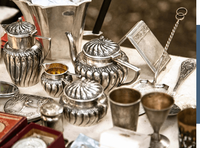 Come explore the household items sale at a flea market, where you can find exquisite antique silverware waiting to be discovered.