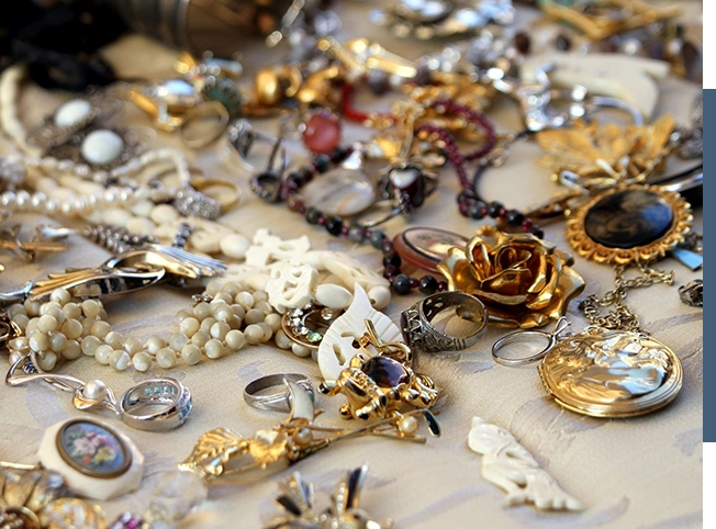 A pile of gold and silver jewelry on a table, perfect for a home liquidation.