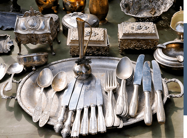A silver plate with silverware on it, available for purchase as part of a merchandising service.
