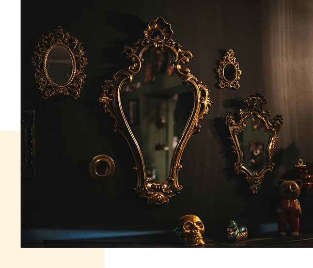 About Come Find Your Treasure: A black wall adorned with striking gold mirrors and a captivating skull.
